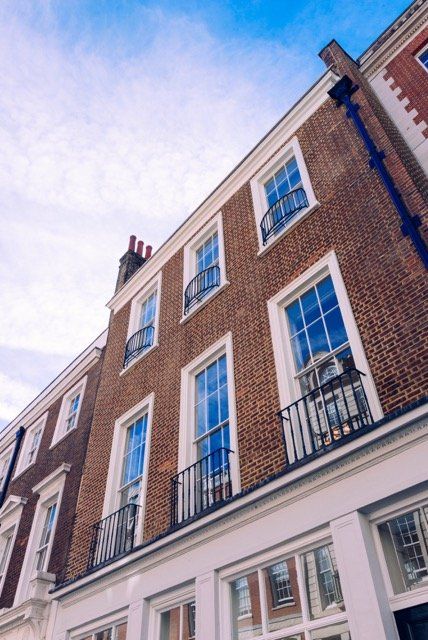 A brick building with a lot of windows and balconies