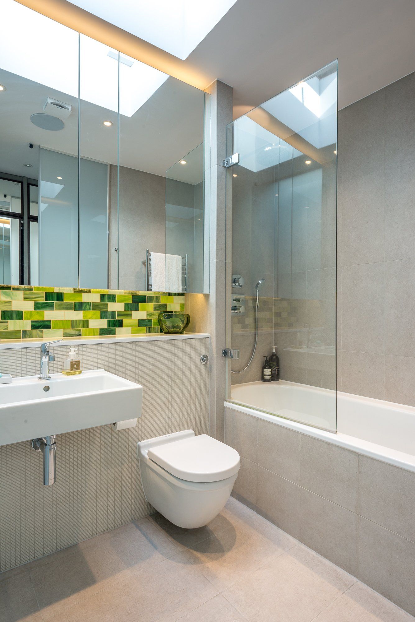 A bathroom with a toilet a sink and a bathtub