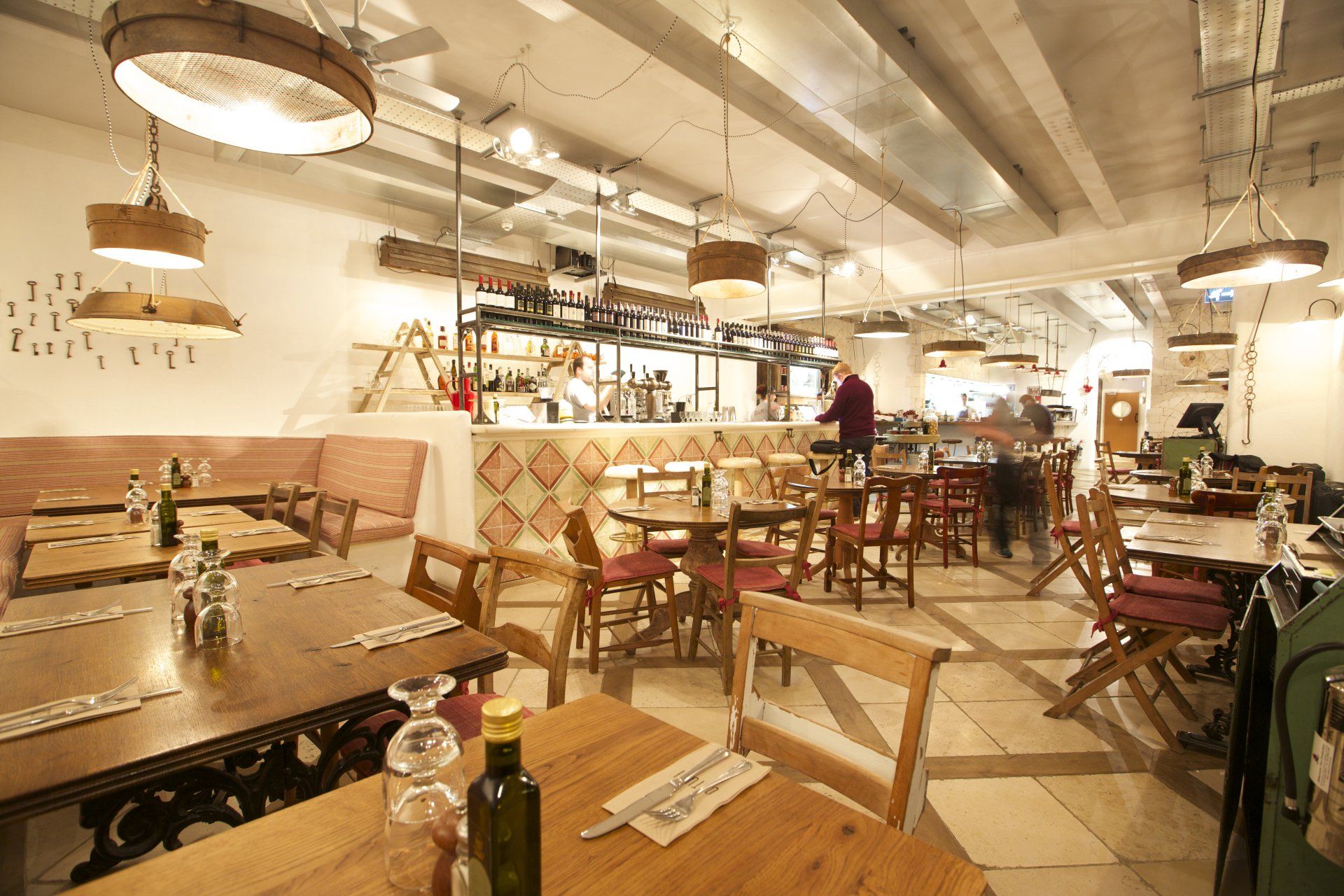 A bottle of olive oil sits on a table in a restaurant