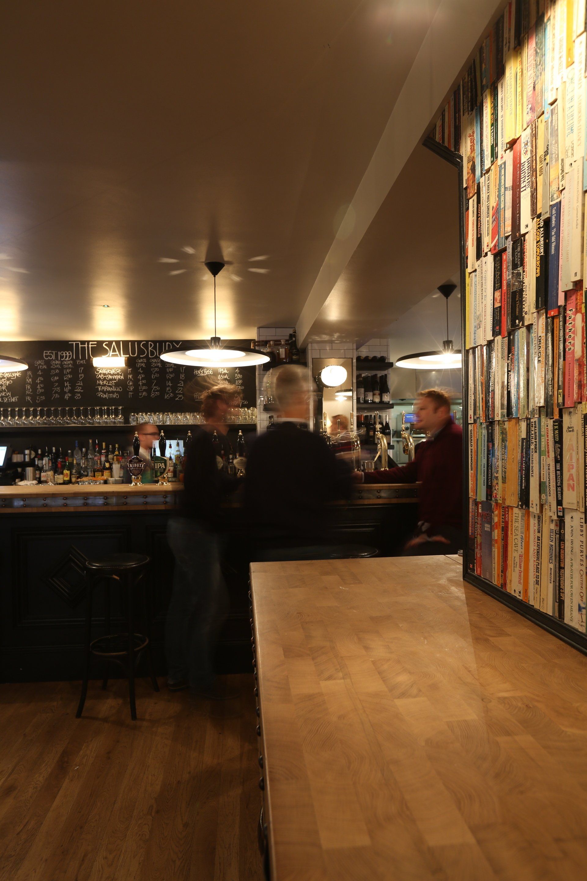 A blurred image of people sitting at tables in a restaurant