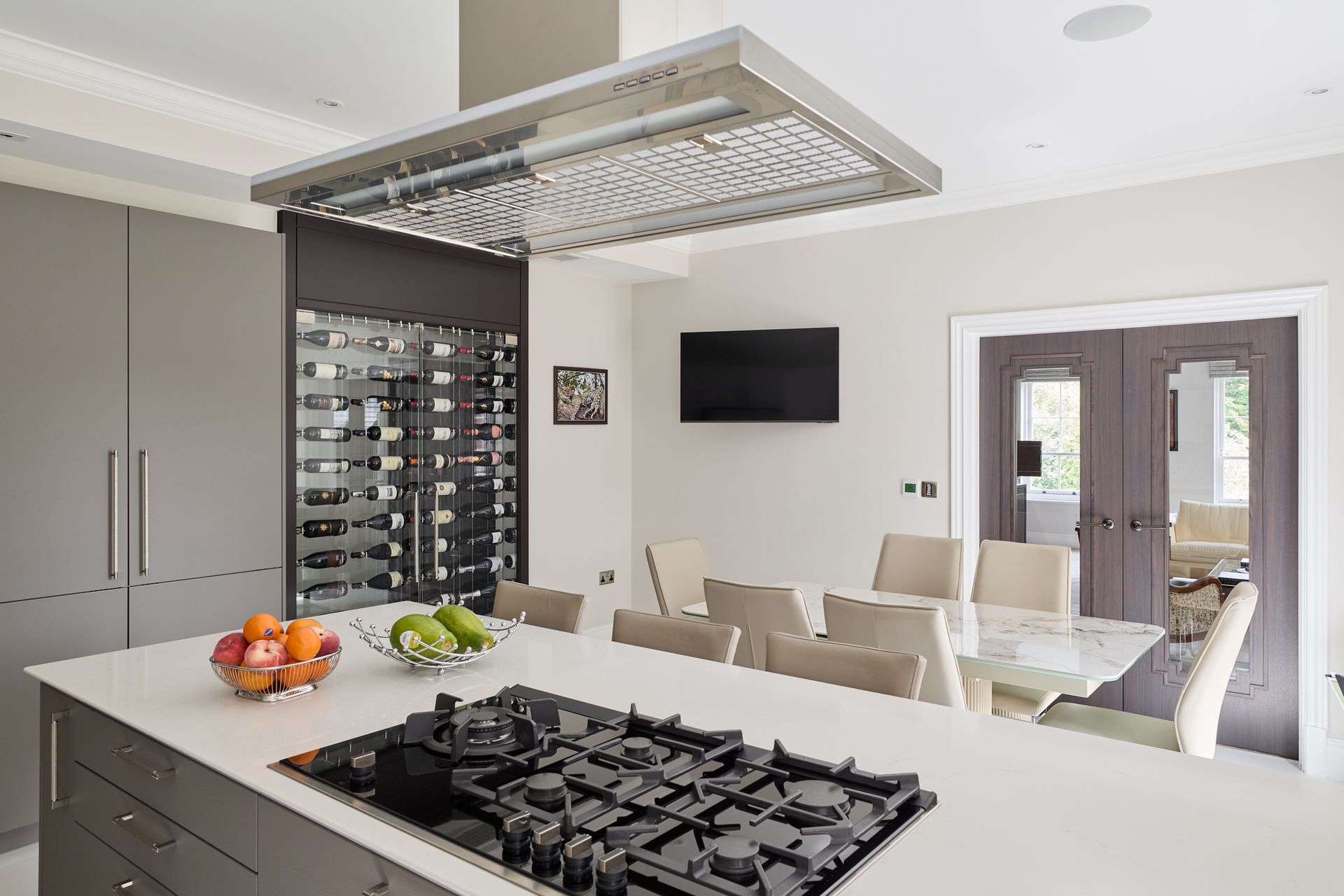 A kitchen with a large island and a stove top oven