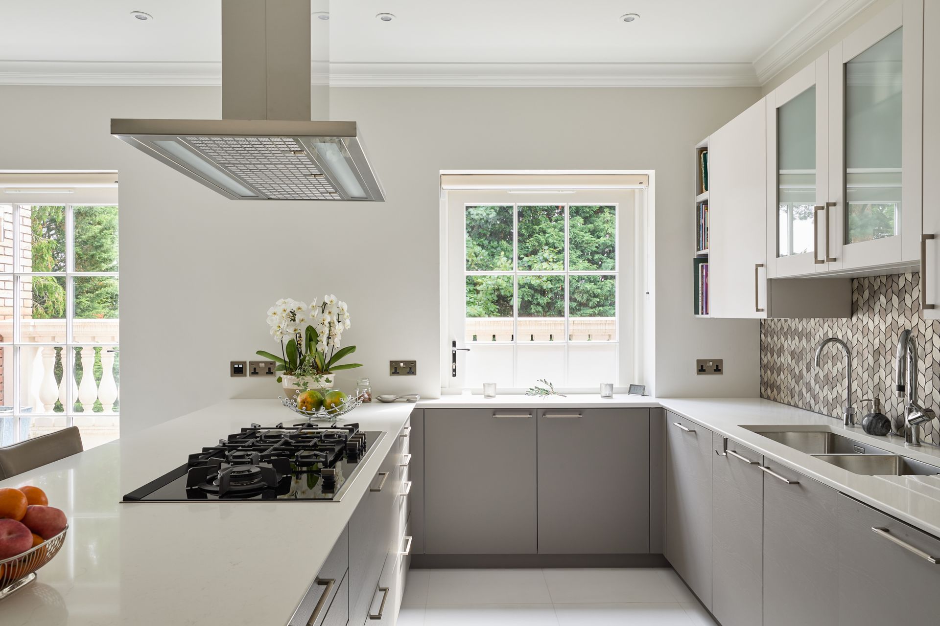 A kitchen with white cabinets and a stove top oven