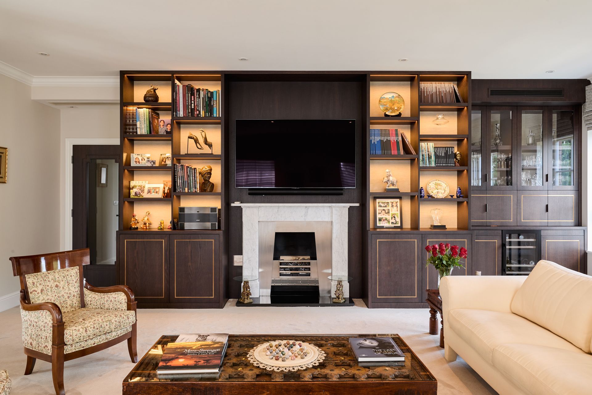 A living room with a fireplace and a flat screen tv