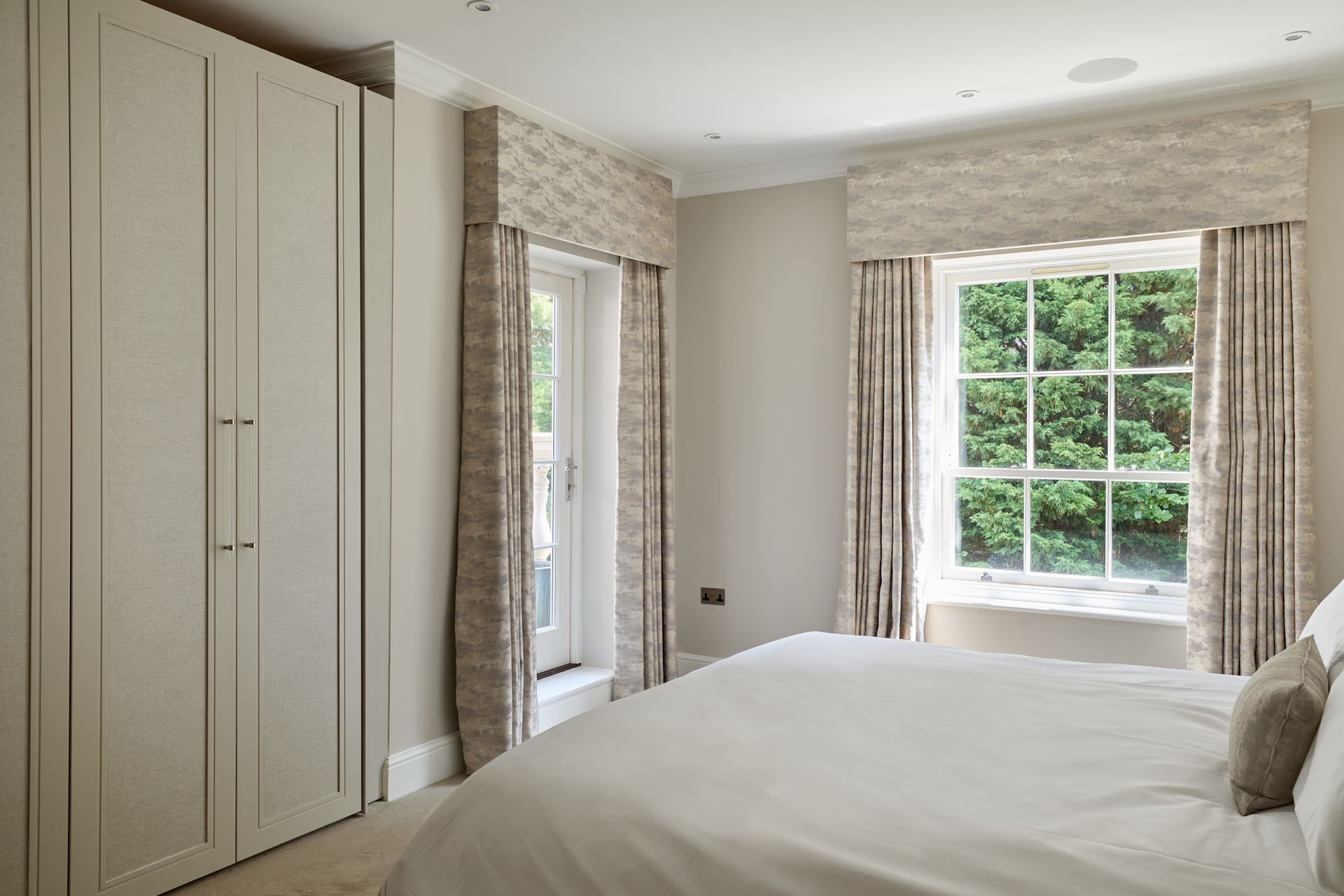 A bedroom with a large bed and a window