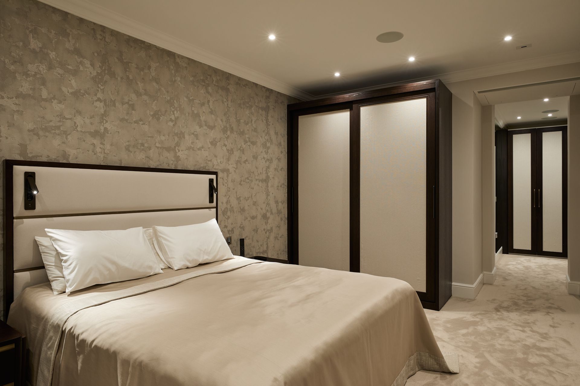 A bedroom with a large bed and sliding doors