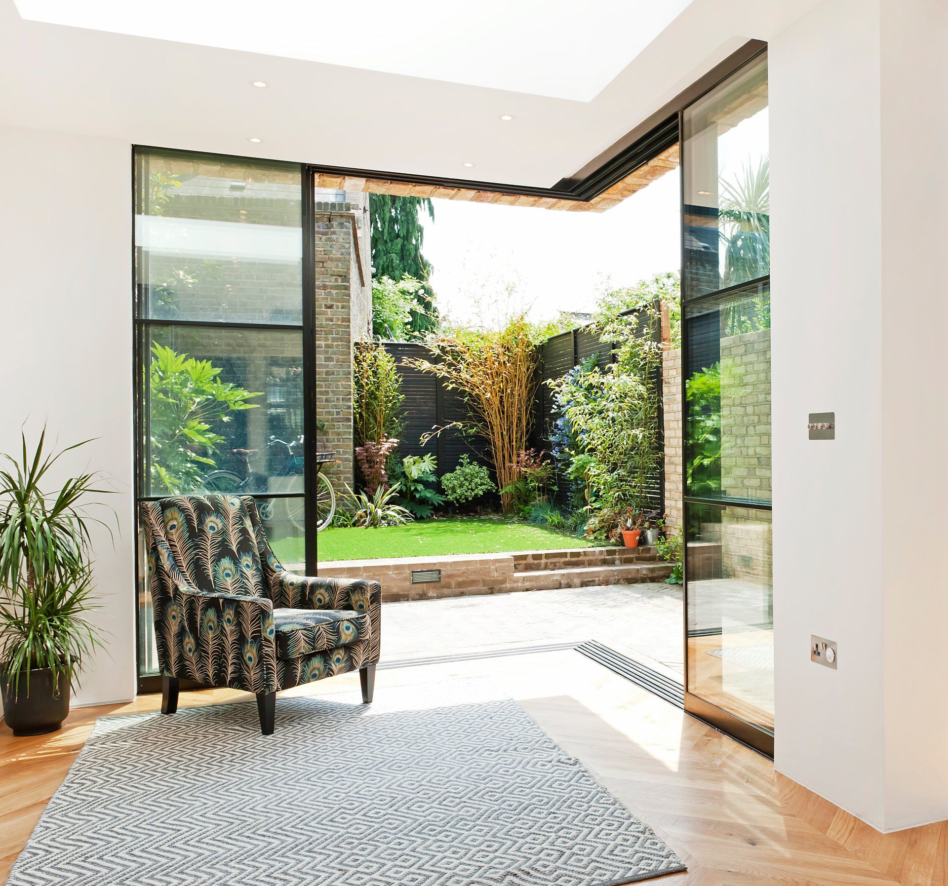 A living room with a chair and a rug