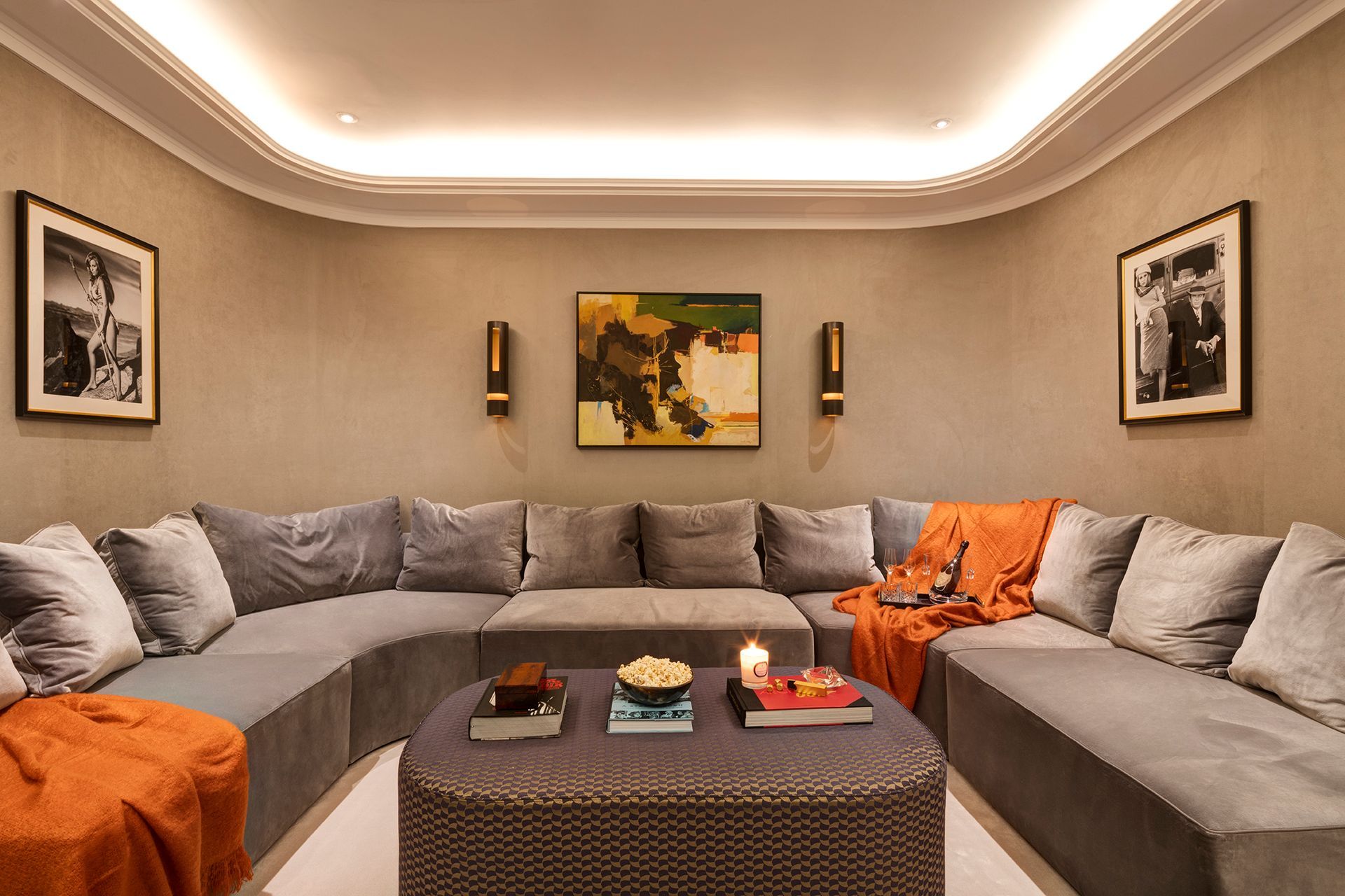 A living room with a large sectional couch and a coffee table