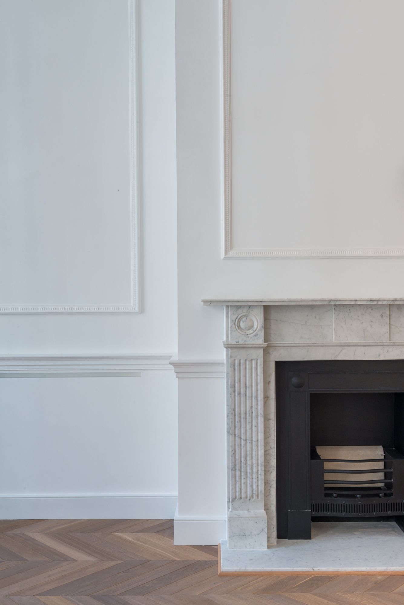 A fireplace in a room with white walls