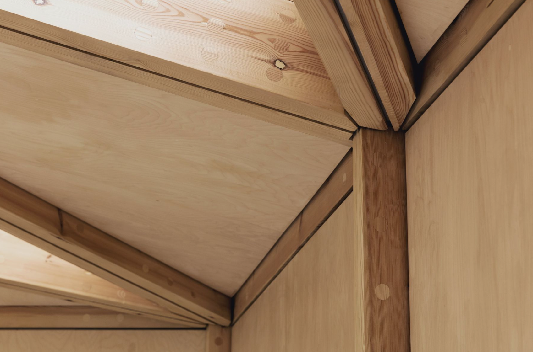 A close up of a wooden structure with a ceiling