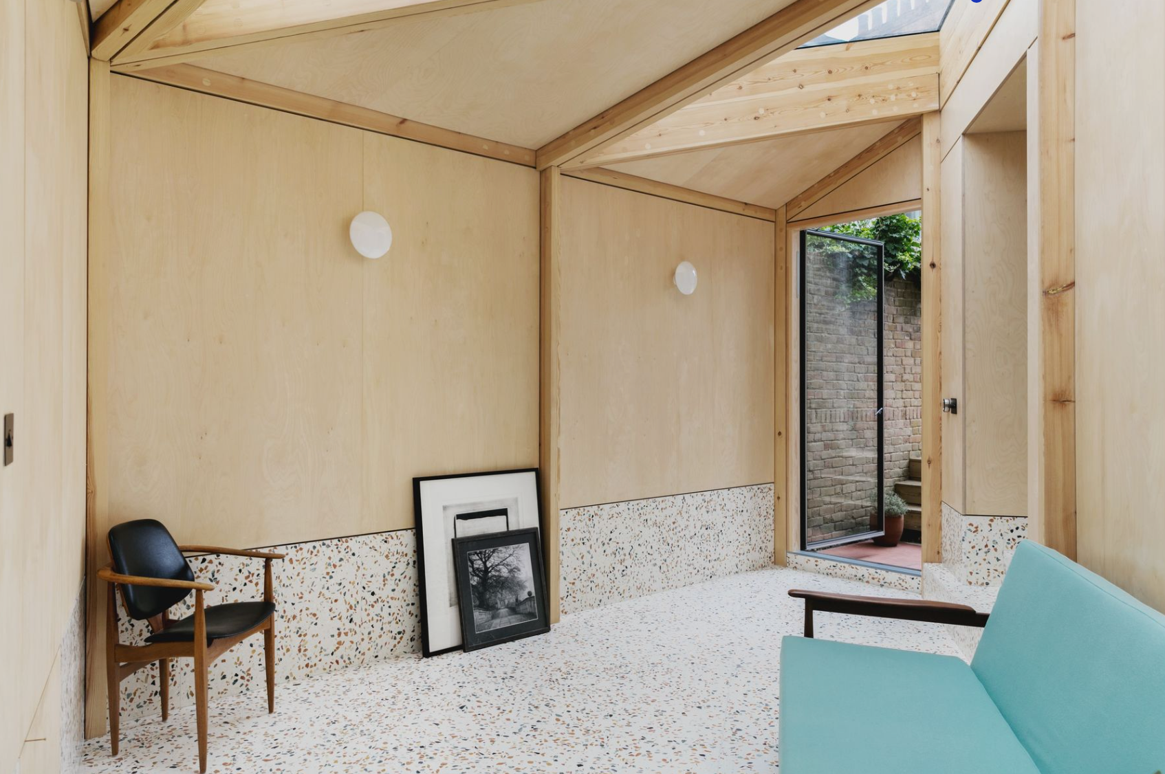 A living room with a blue couch and a chair