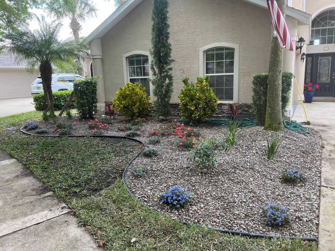 A house with a flag in front of it and a garden in front of it.
