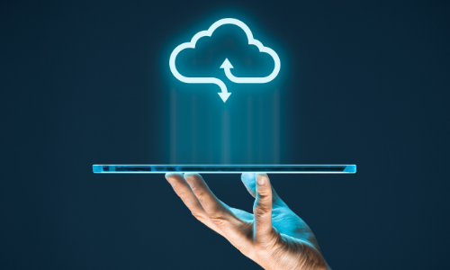 Hand holding a tablet with a glowing cloud icon above, symbolizing cloud computing.