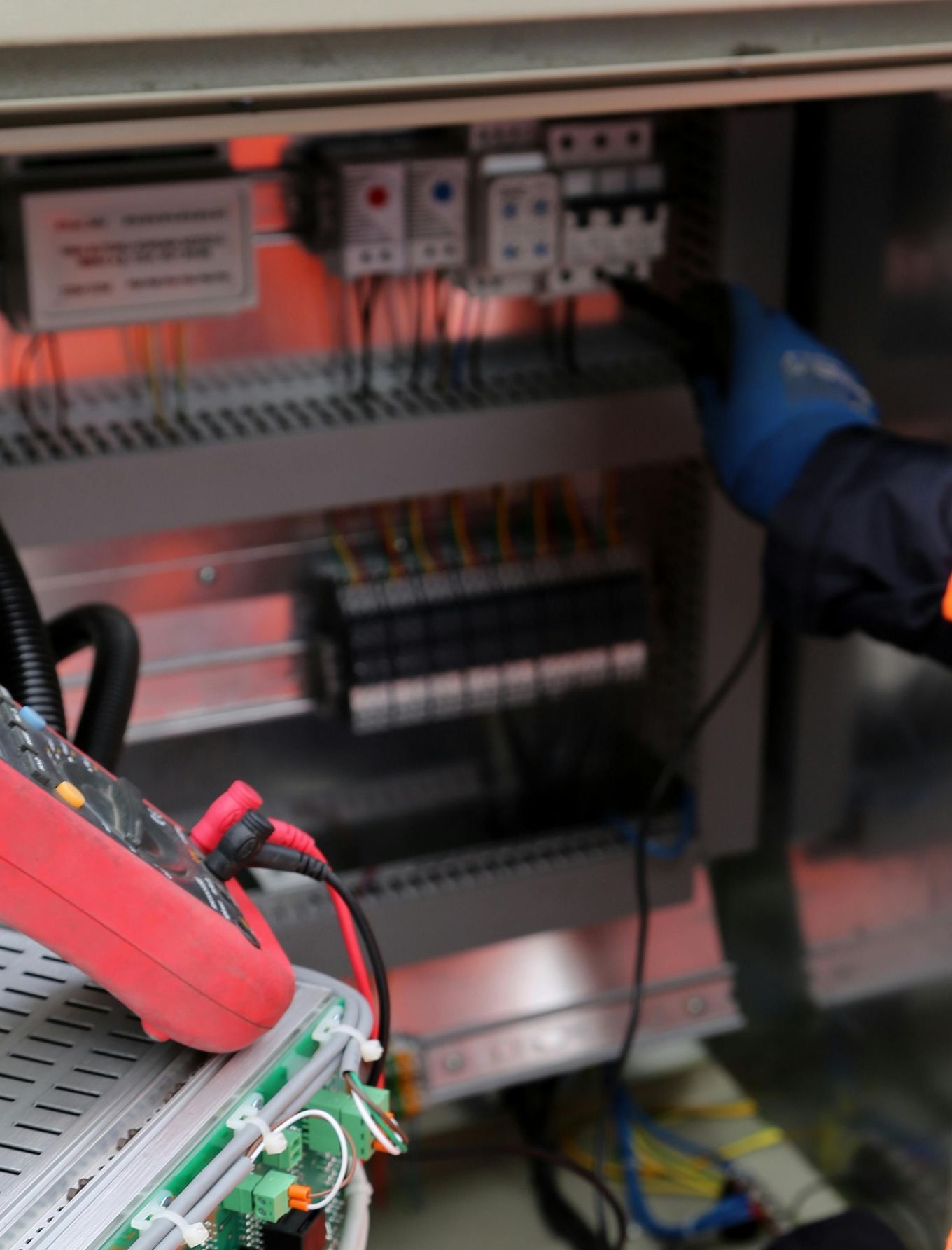 A large white generator is sitting in the middle of a lush green field.