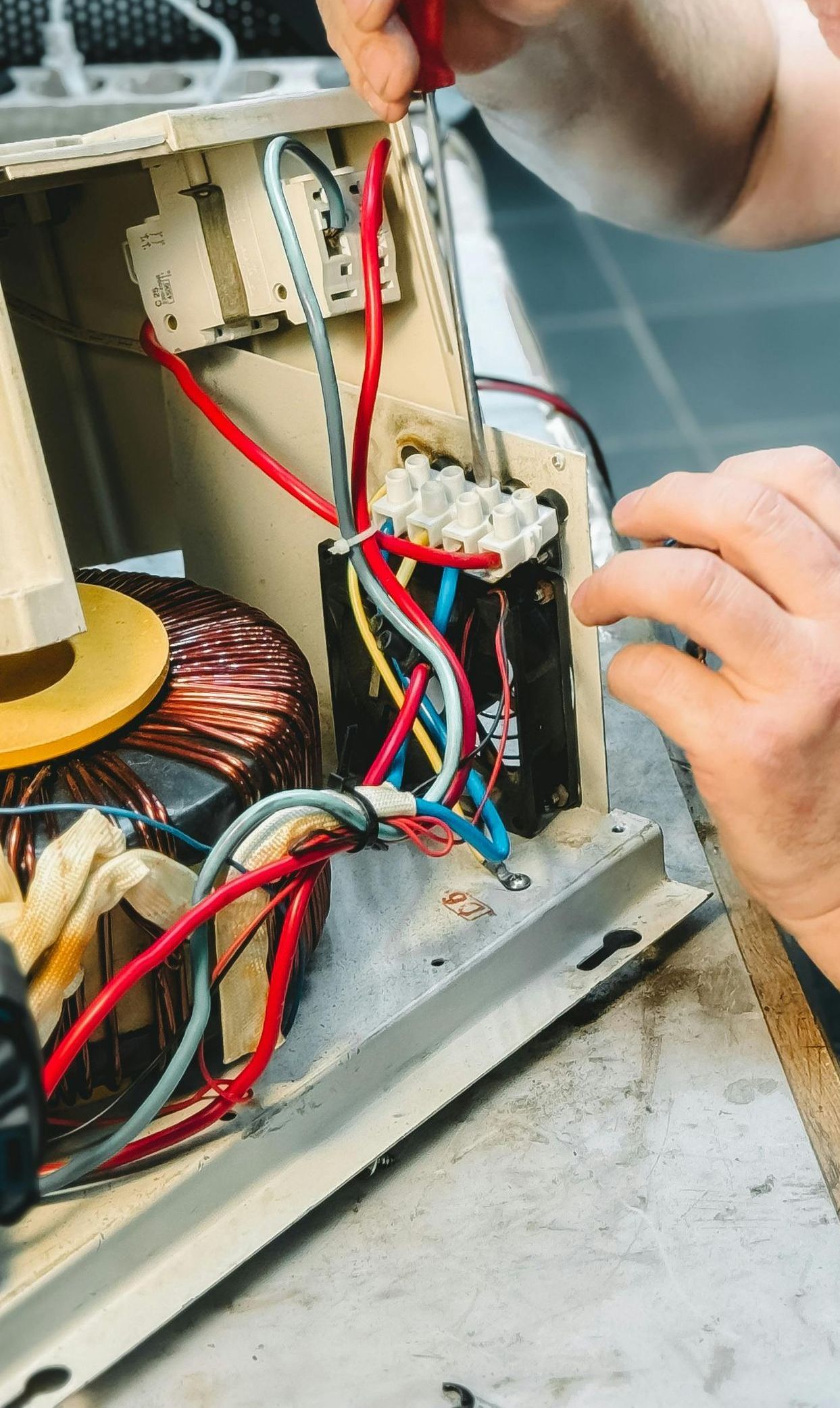 A large white and black generator is parked in front of a building.