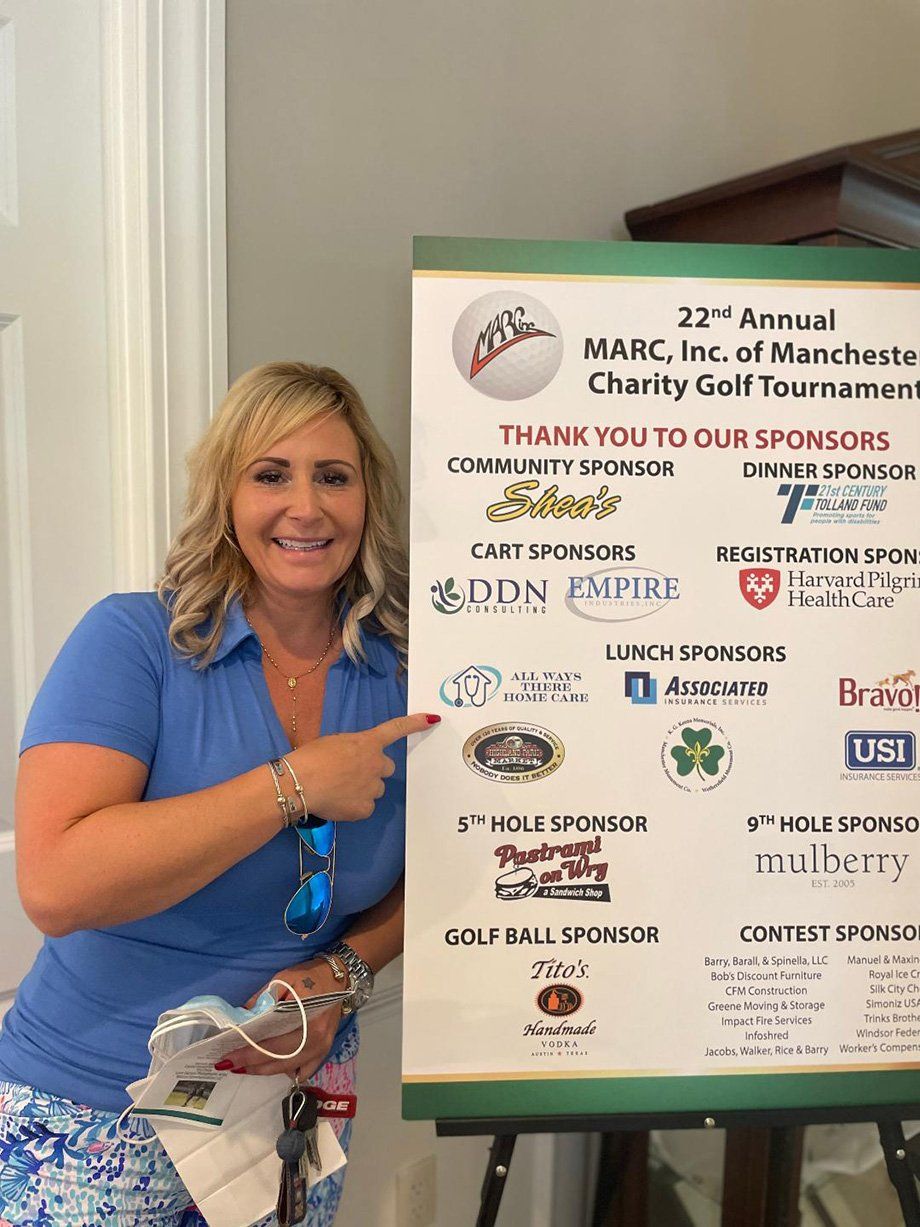 woman with marc golf tournament sign