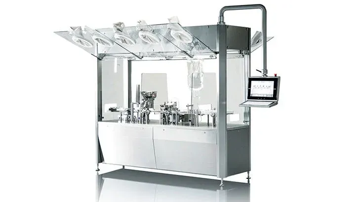 Stainless steel pharmaceutical machine with glass vials, filling and sealing liquids, with a computer monitor.