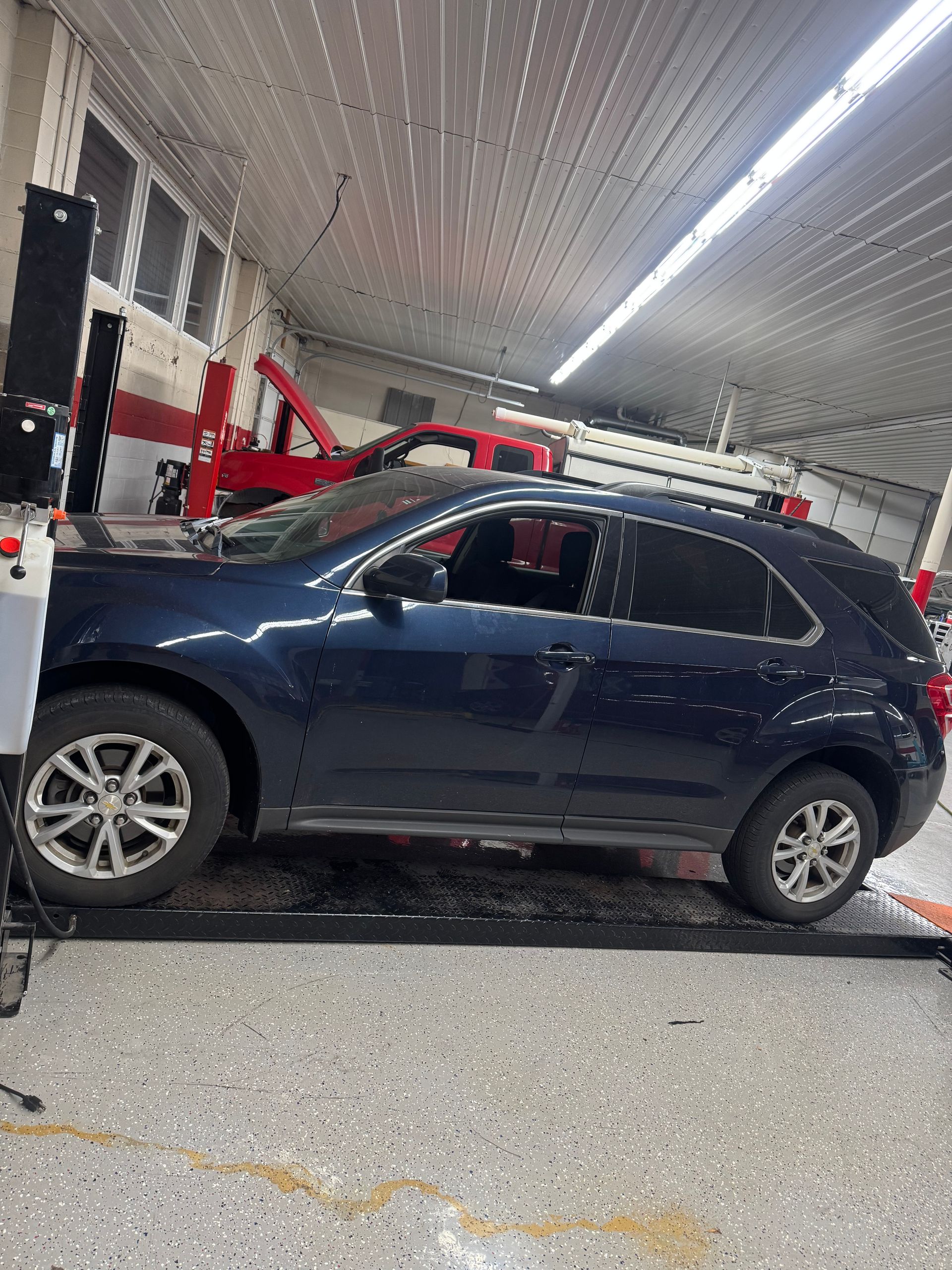 Vehicle Positioned On Lift For Professional Auto Repair Service | Dustin's Automotive Service Center