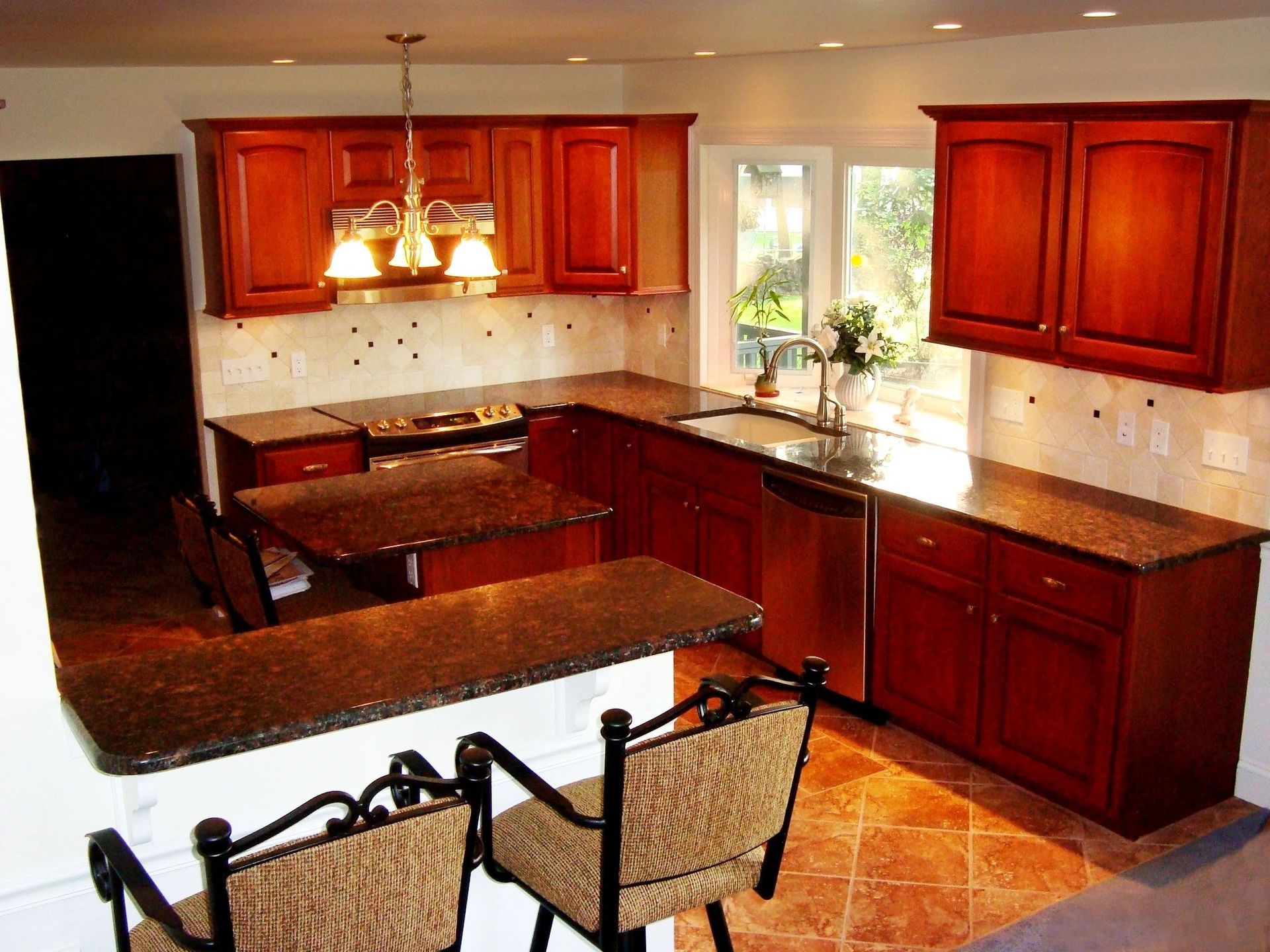 A kitchen with wooden cabinets and granite counter tops