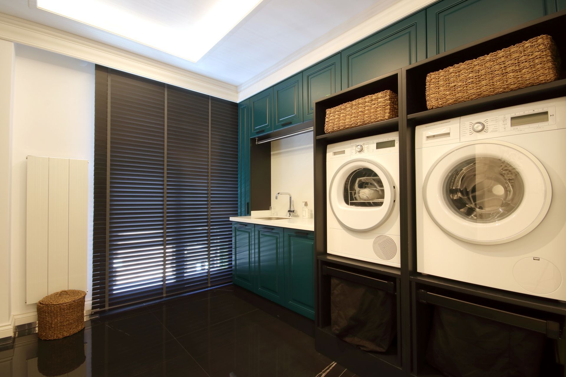 A laundry room with a washer and dryer stacked on top of each other.