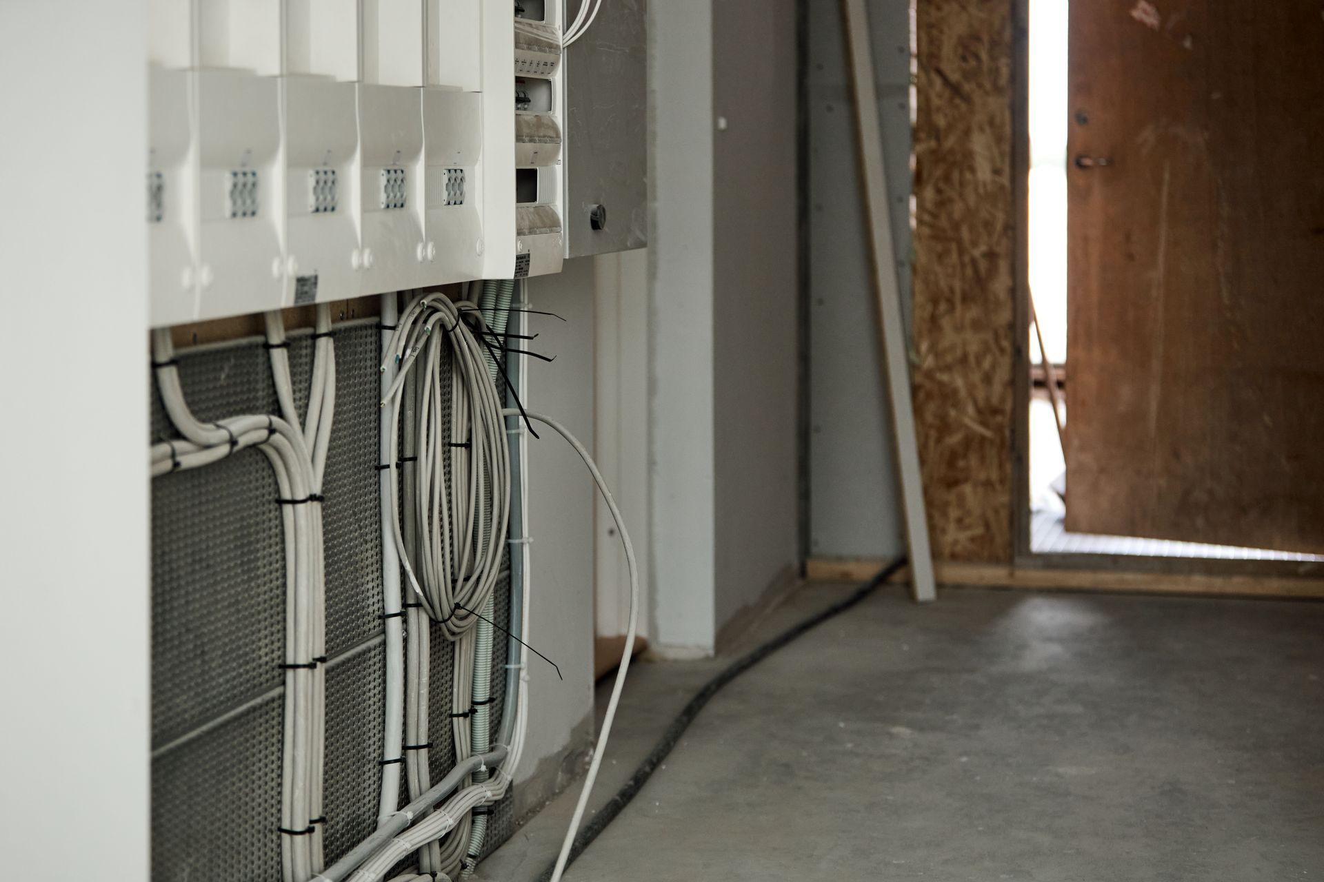A room with a lot of wires hanging from the wall