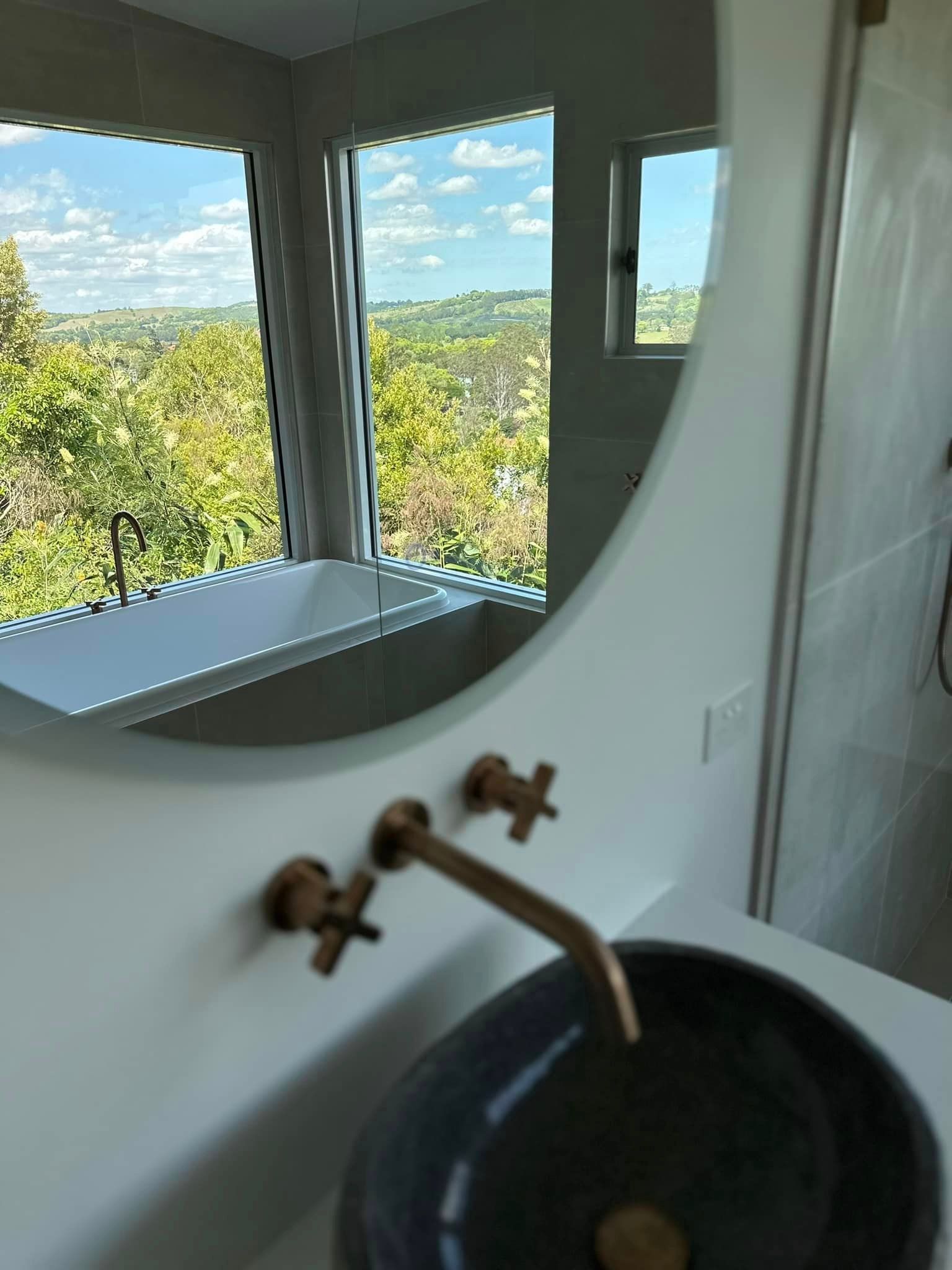 A bathroom with a sink and a large mirror