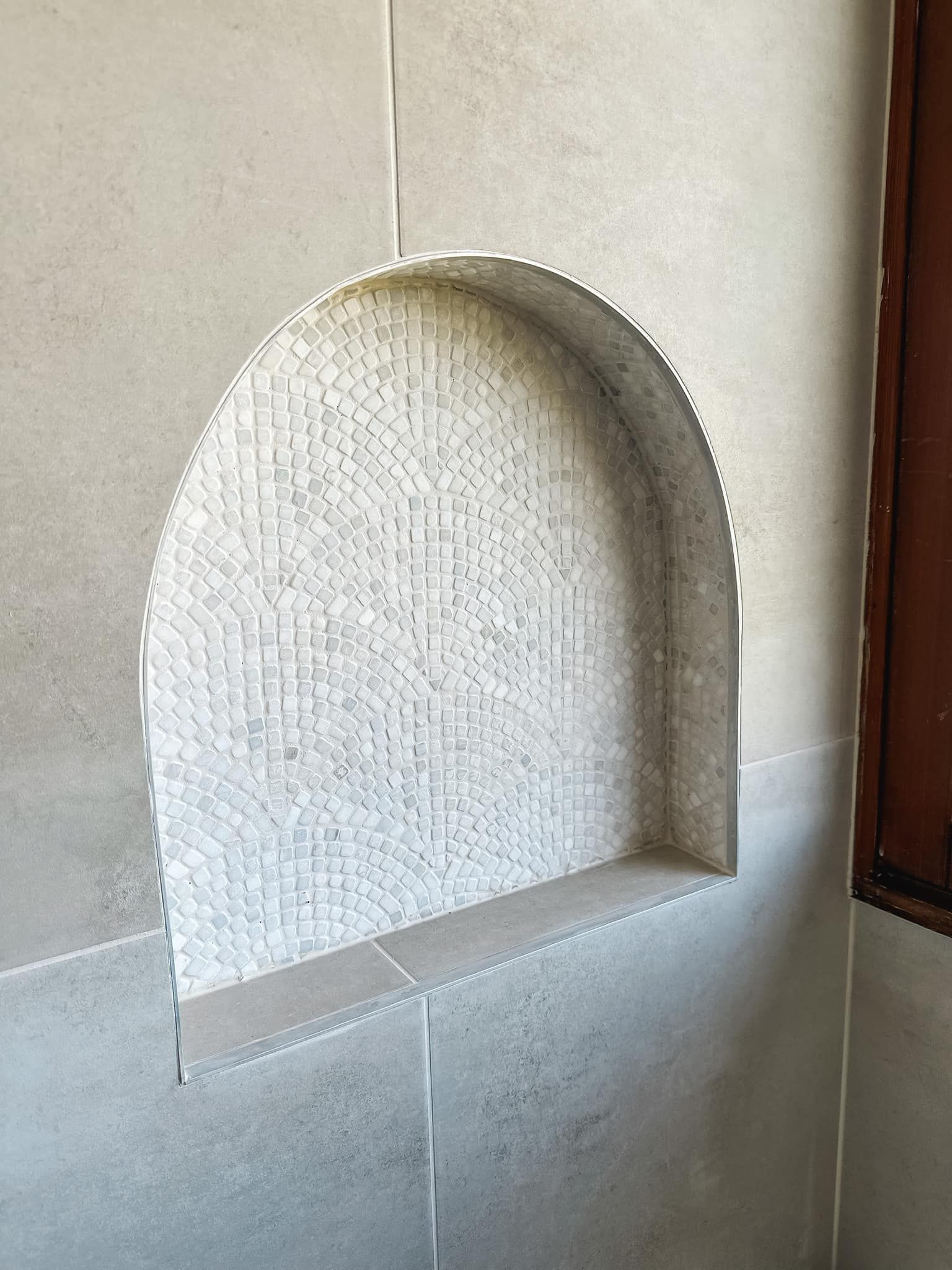 There is a niche in the wall that looks like a window.