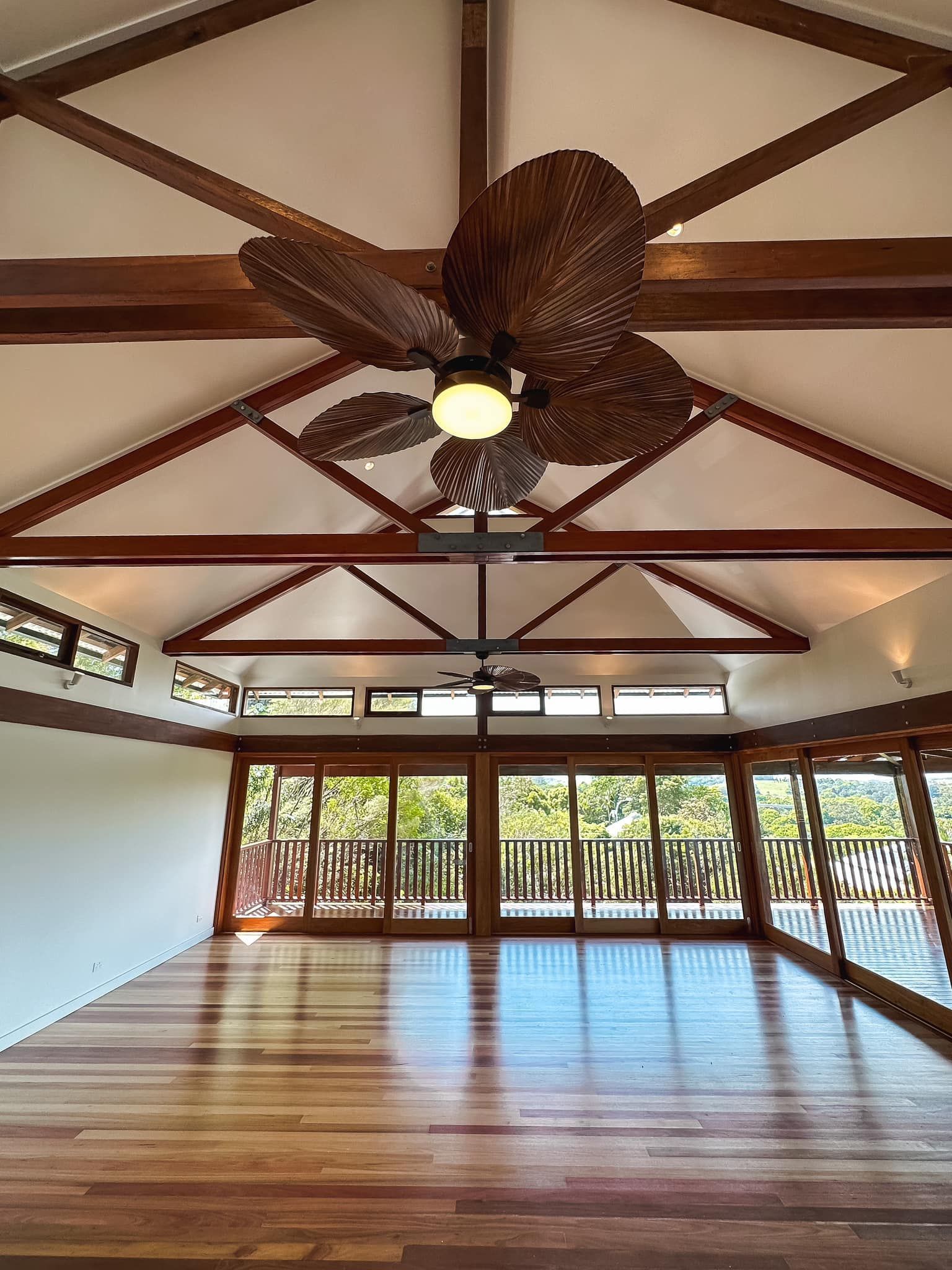 There is a ceiling fan in the middle of the room.