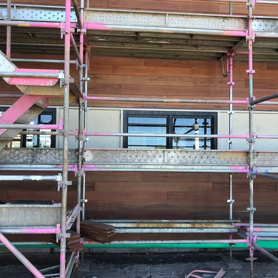a building is being built with scaffolding in front of it .