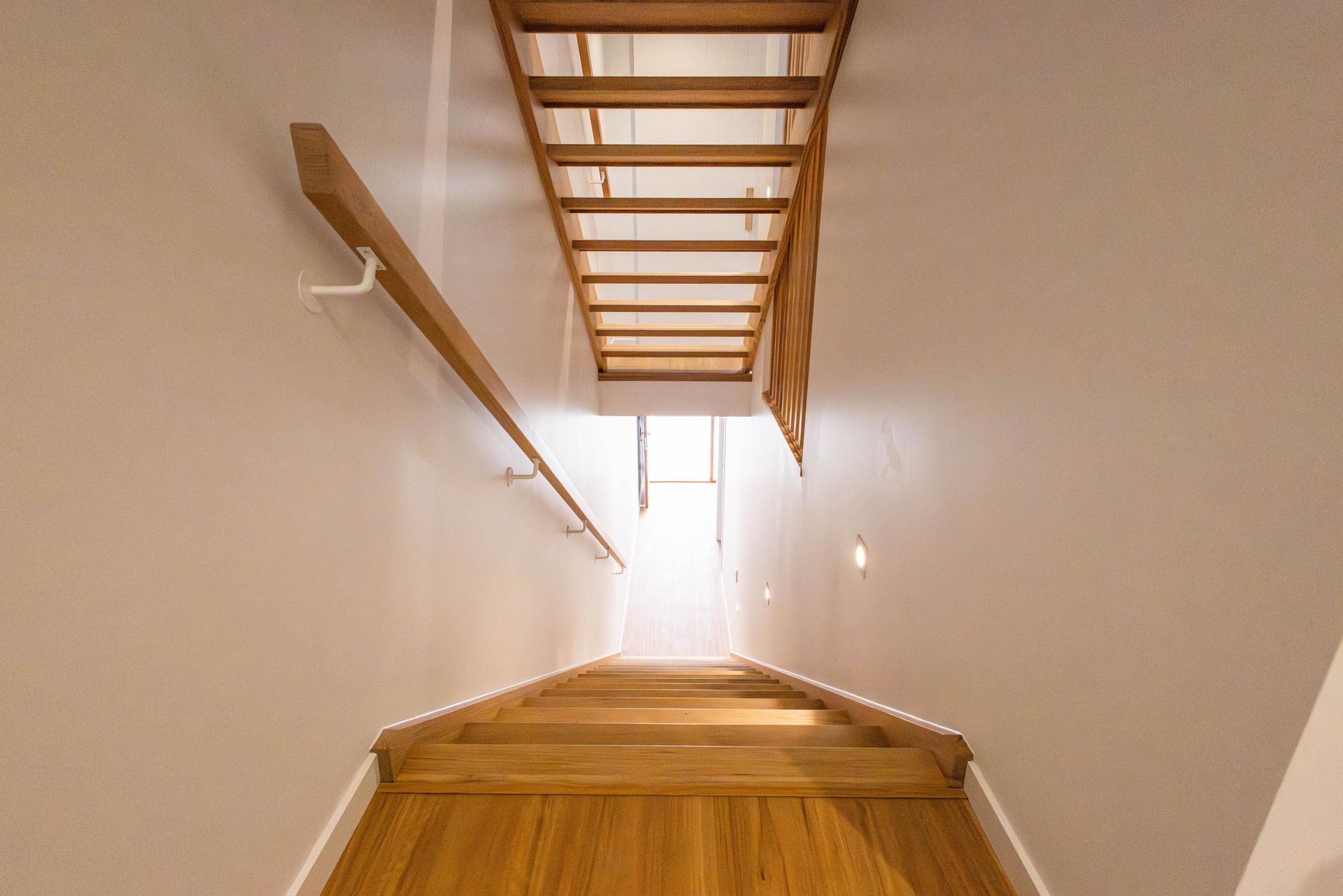 A wooden staircase leading up to the second floor of a house.