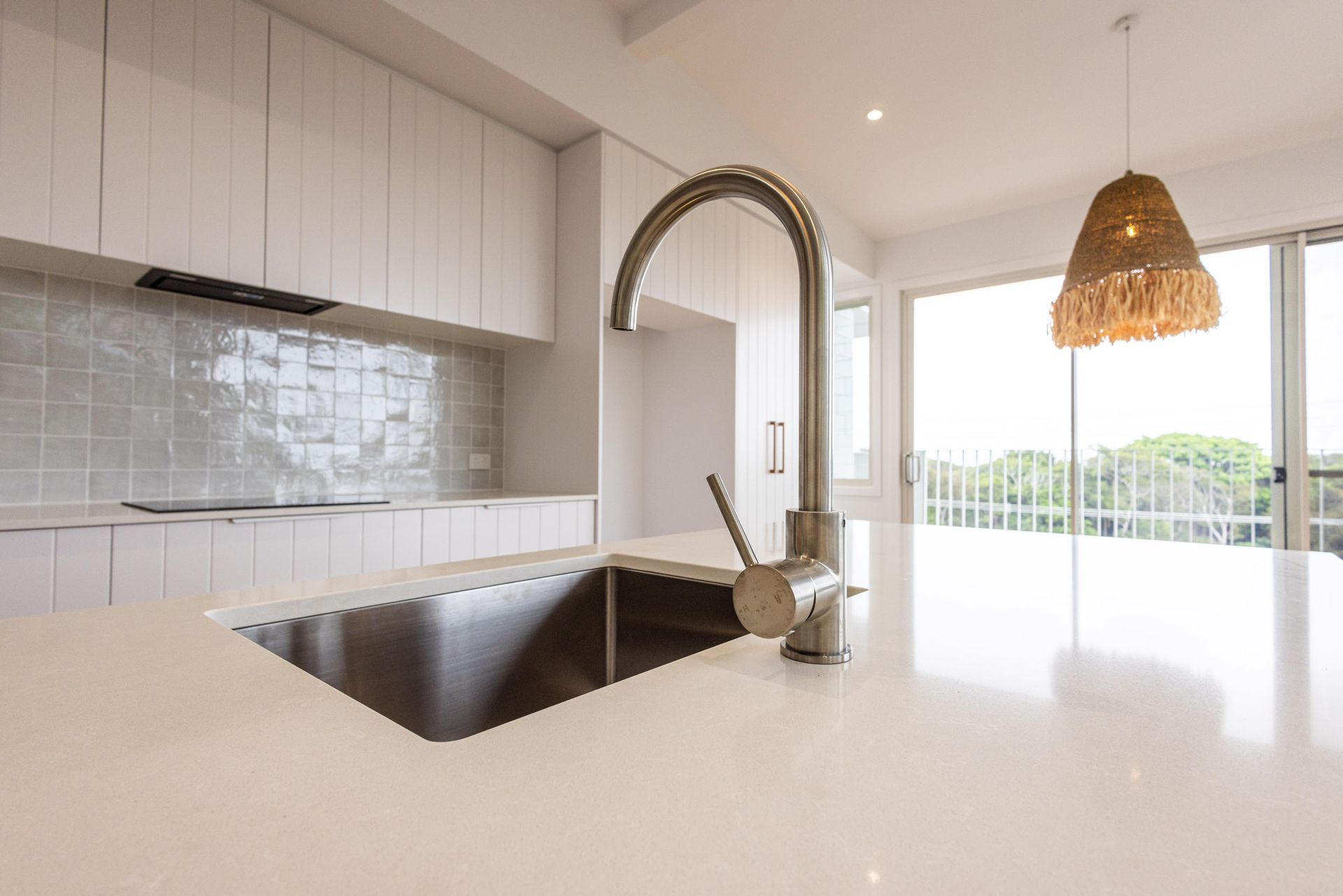 A kitchen with a sink and a faucet on the counter.