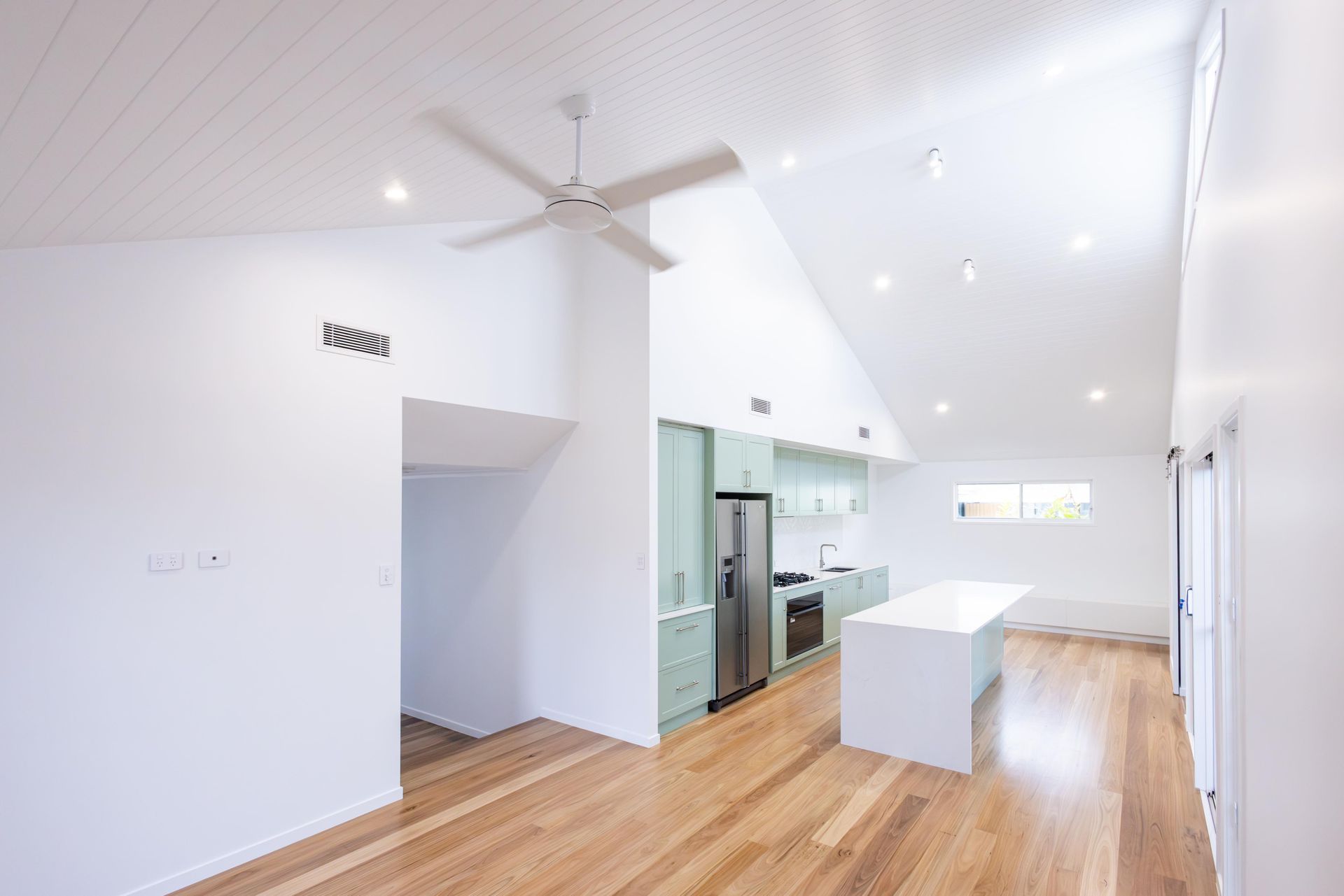 There is a ceiling fan in the middle of the room.