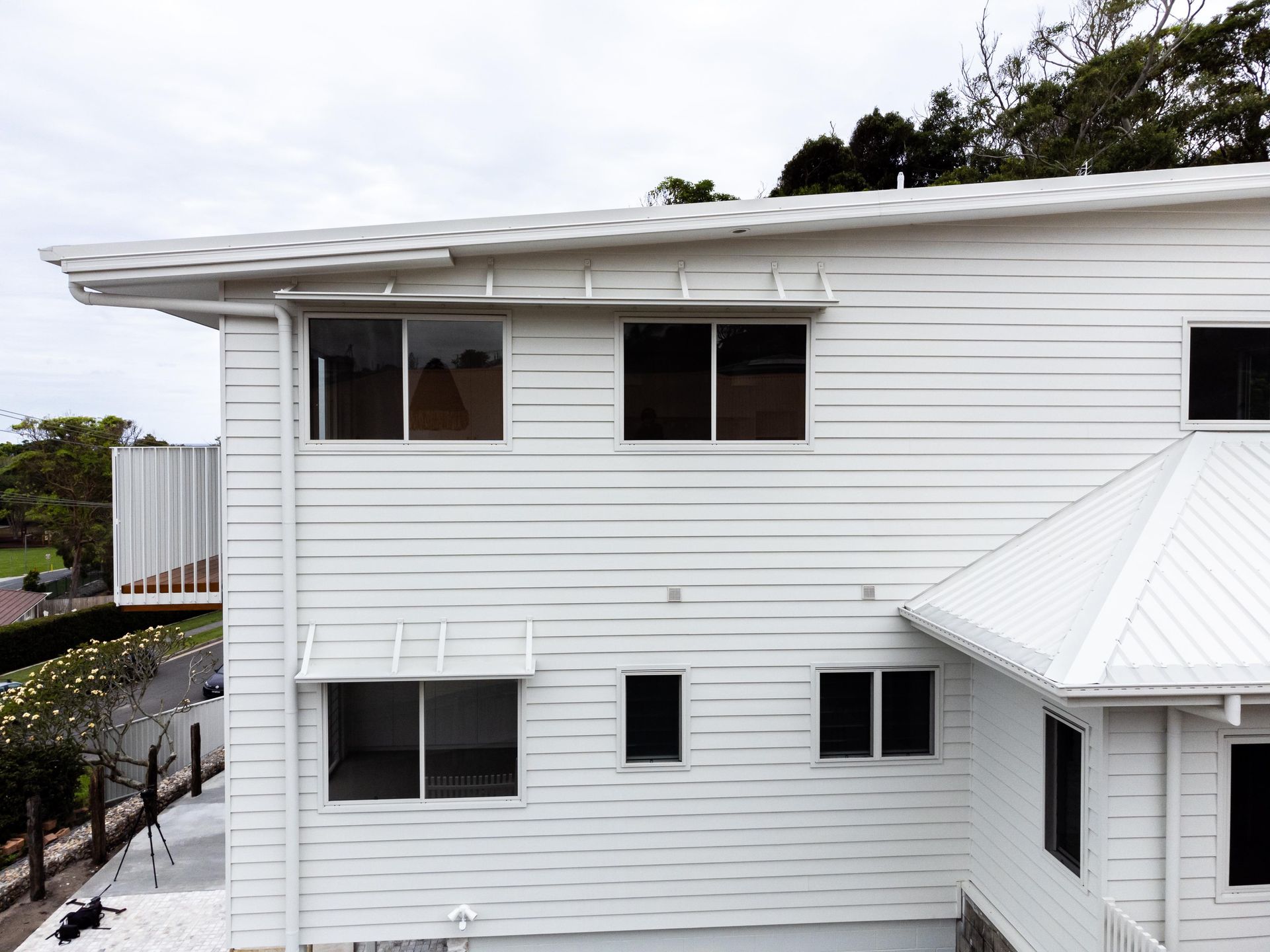 A white house with a white roof and a lot of windows.