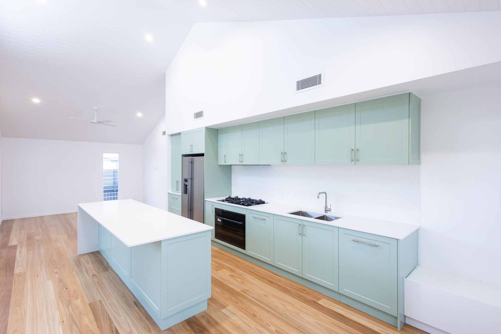 There is a large island in the middle of the kitchen.