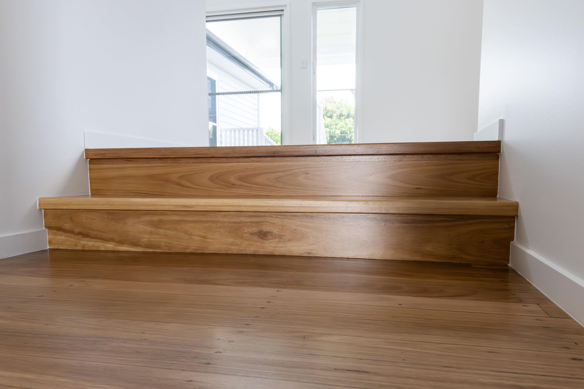 A set of wooden stairs leading up to a second floor in a house.