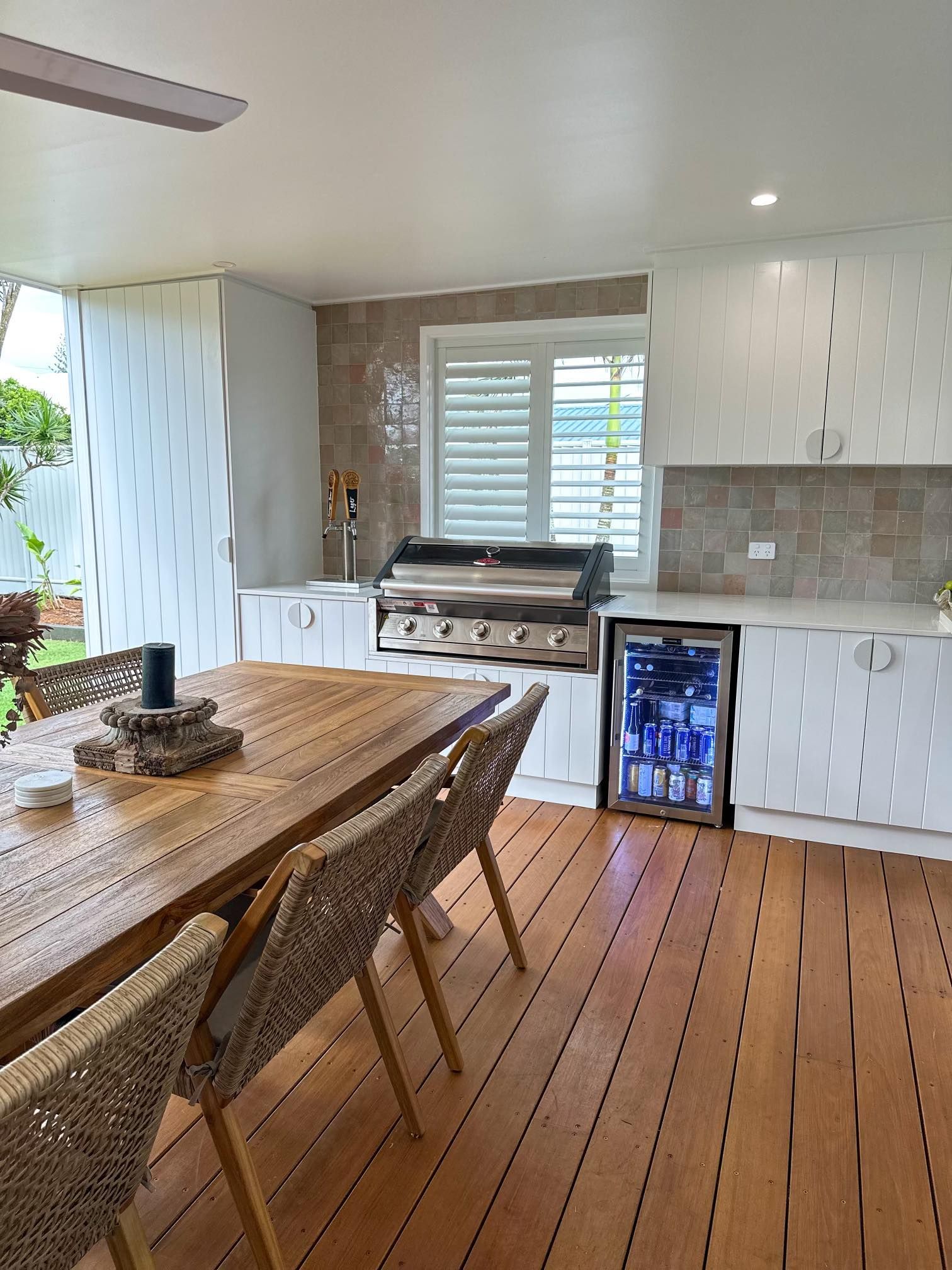 A kitchen with a table and chairs and a refrigerator.