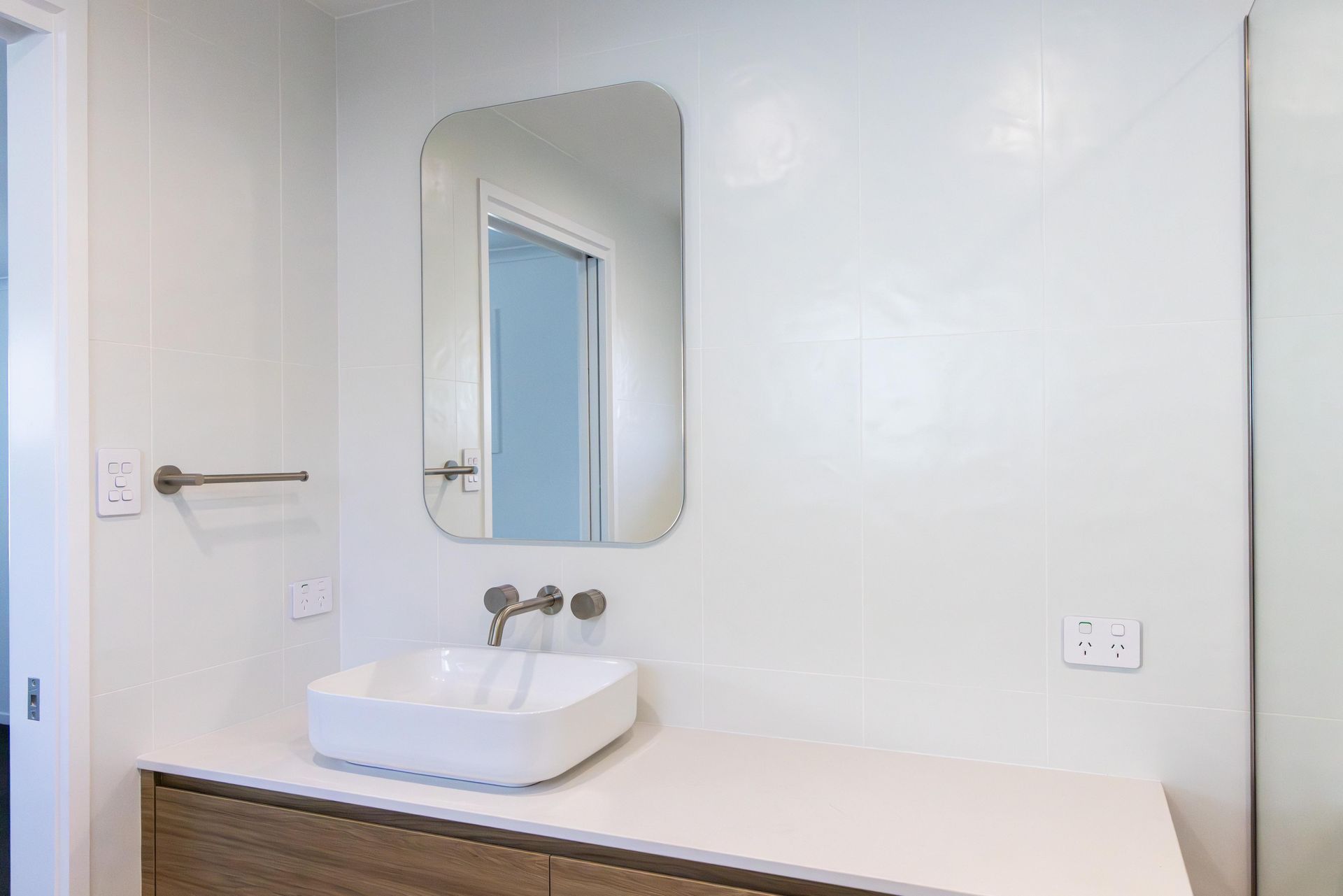 A bathroom with a sink and a mirror on the wall.