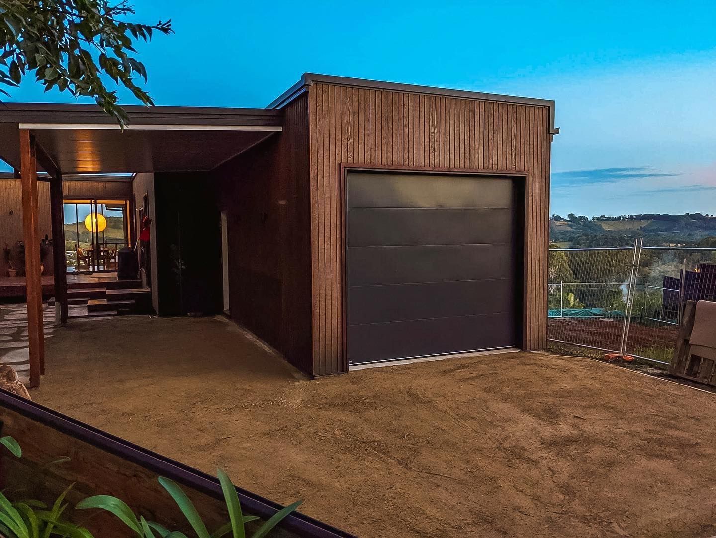 a house with a garage and a driveway in front of it .