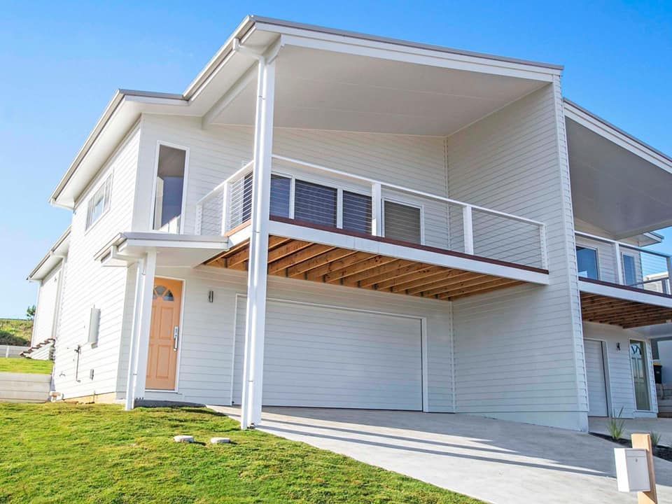 a living room with a couch and chairs and a ceiling fan .