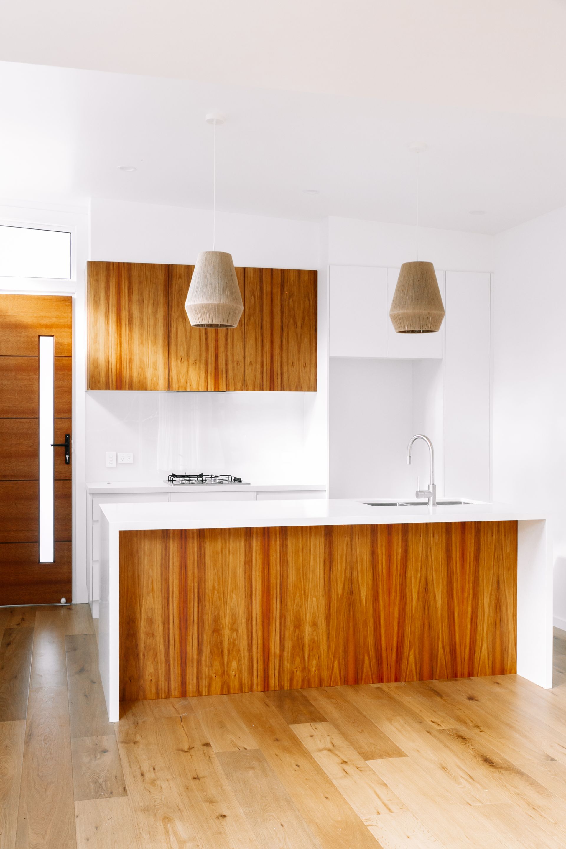 a kitchen with wooden cabinets and a white counter top