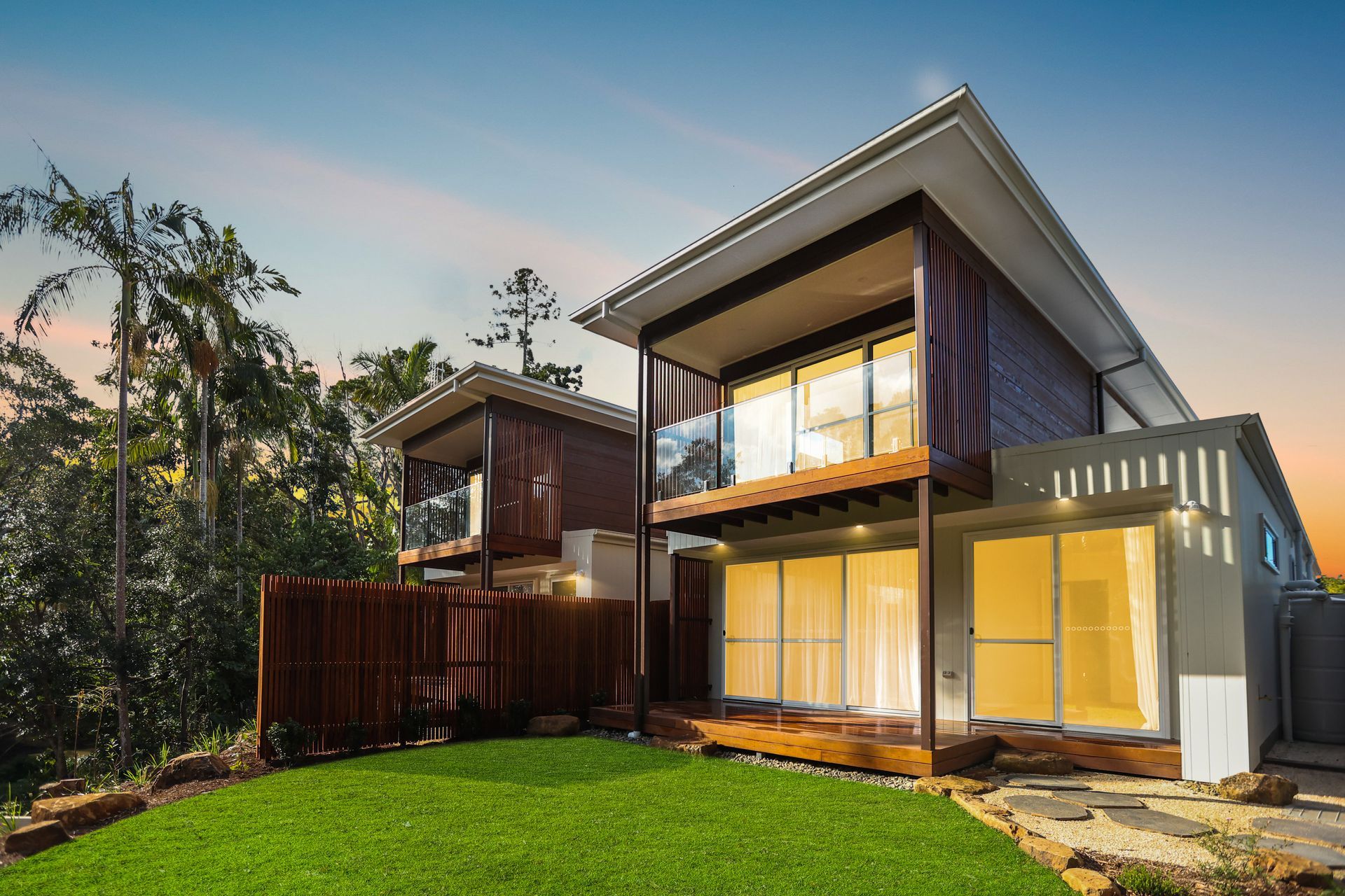 a modern house with a large lawn in front of it .