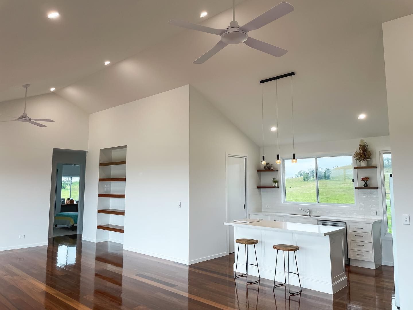 A kitchen with a ceiling fan hanging from the ceiling.