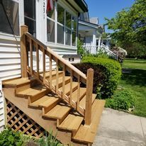 An empty basement with a shelf and a window.