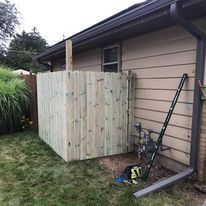 A set of wooden stairs leading up to a house.