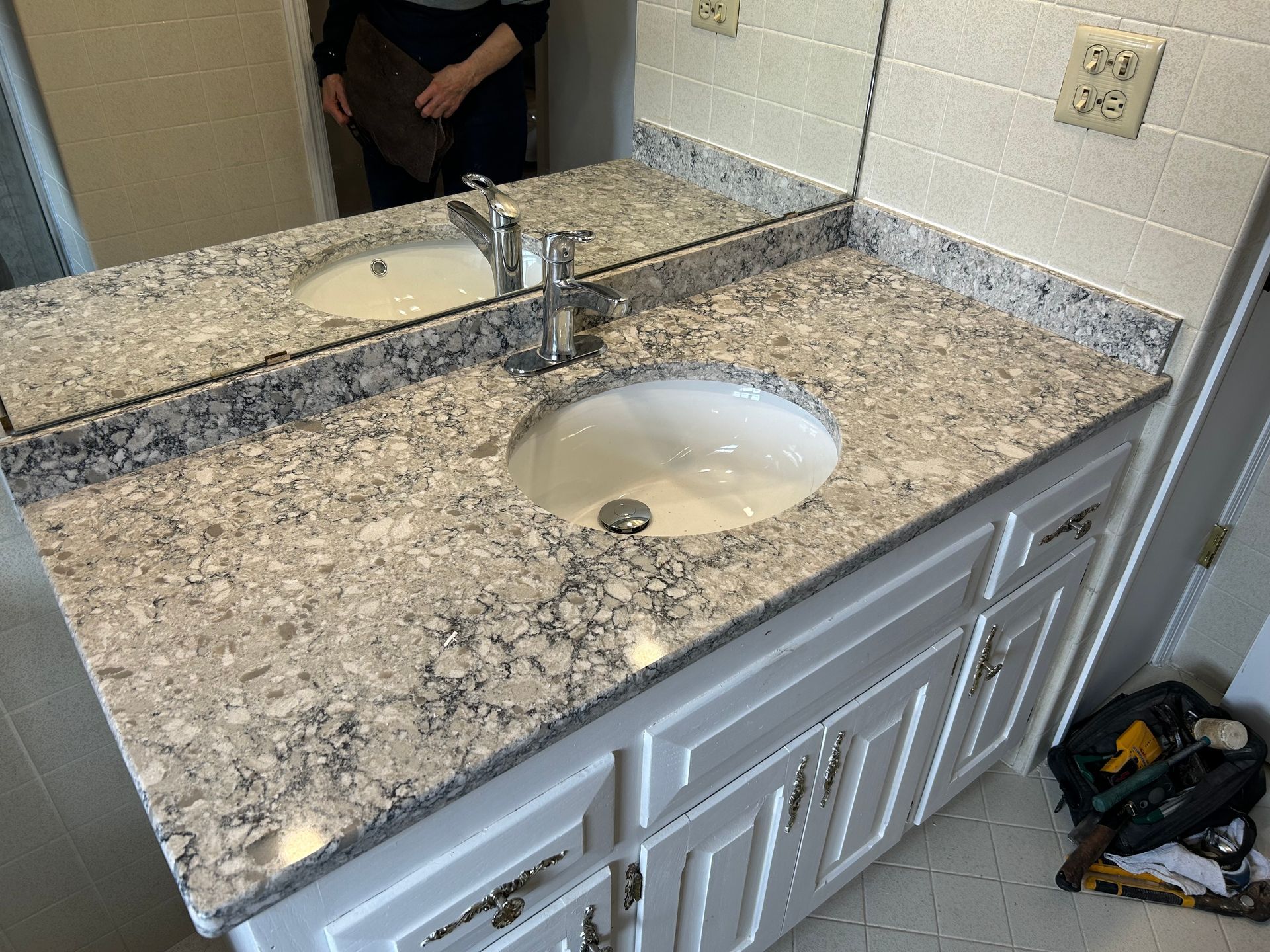 A kitchen with wooden cabinets , a sink , and a window.