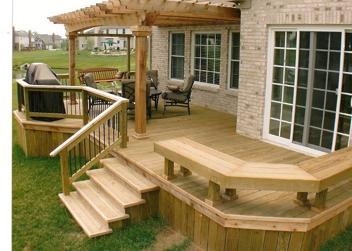 A wooden deck with stairs leading up to it