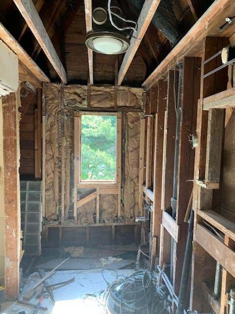 A room with a lot of wooden beams and a window.