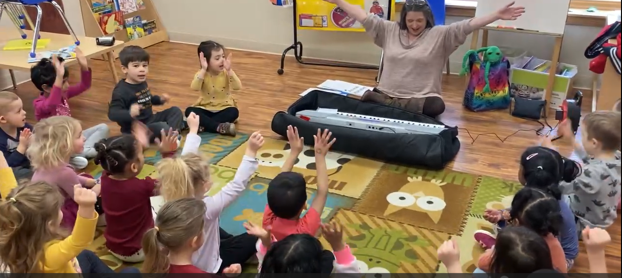 Teacher Playing Instrument in Class