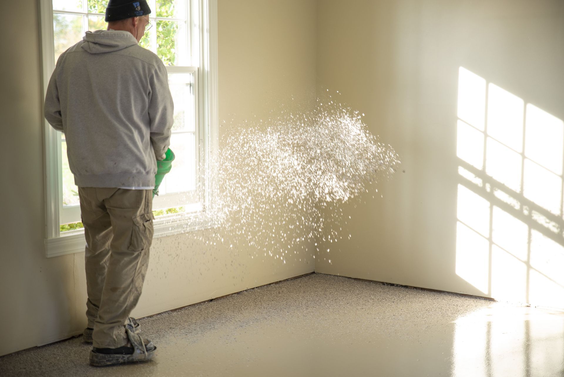 worker maintaining coat of floor