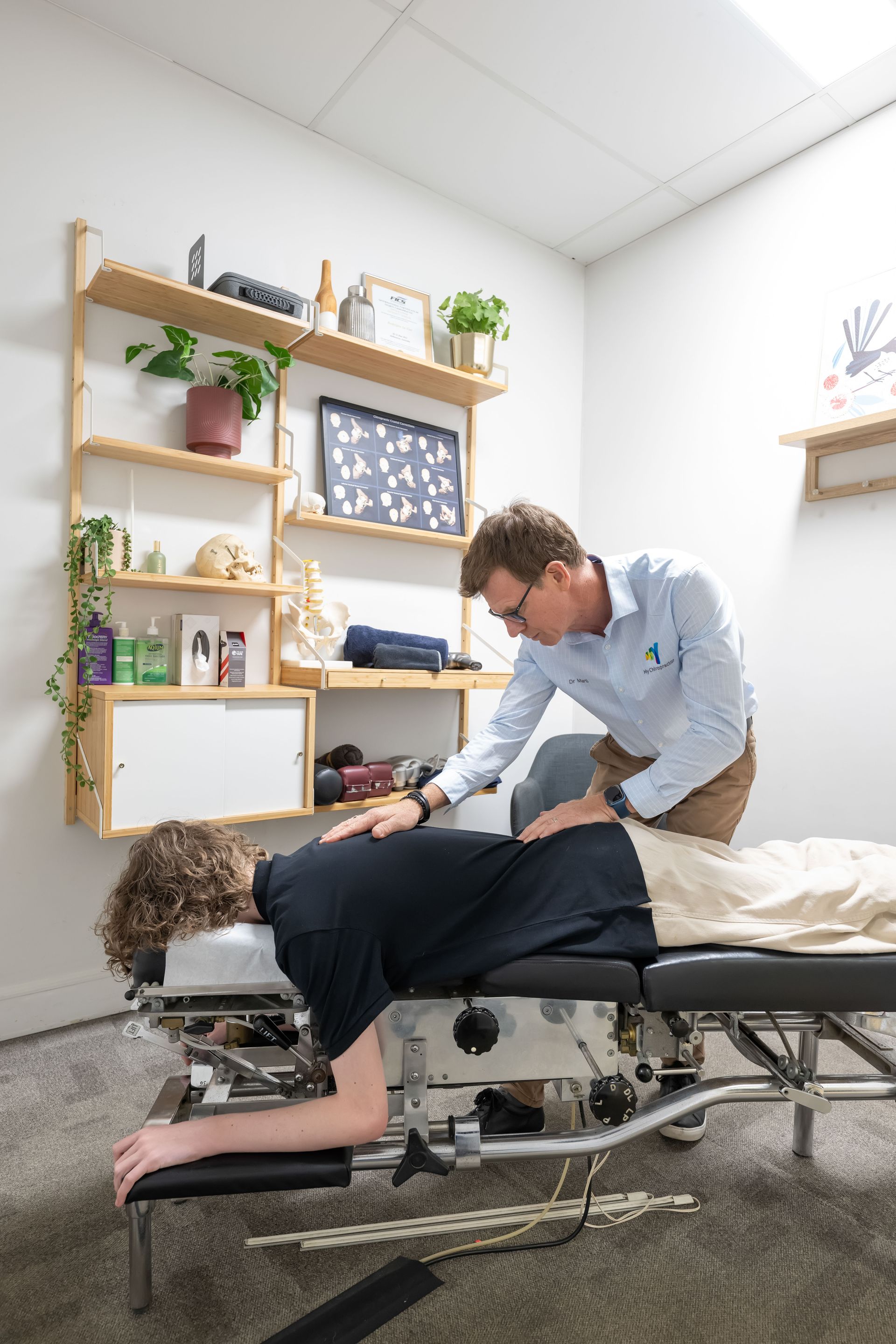Man Receiving Chiropractic Treatment, Doctor Examining Spine — My Chiropractor Mackay City in Airlie Beach, QLD