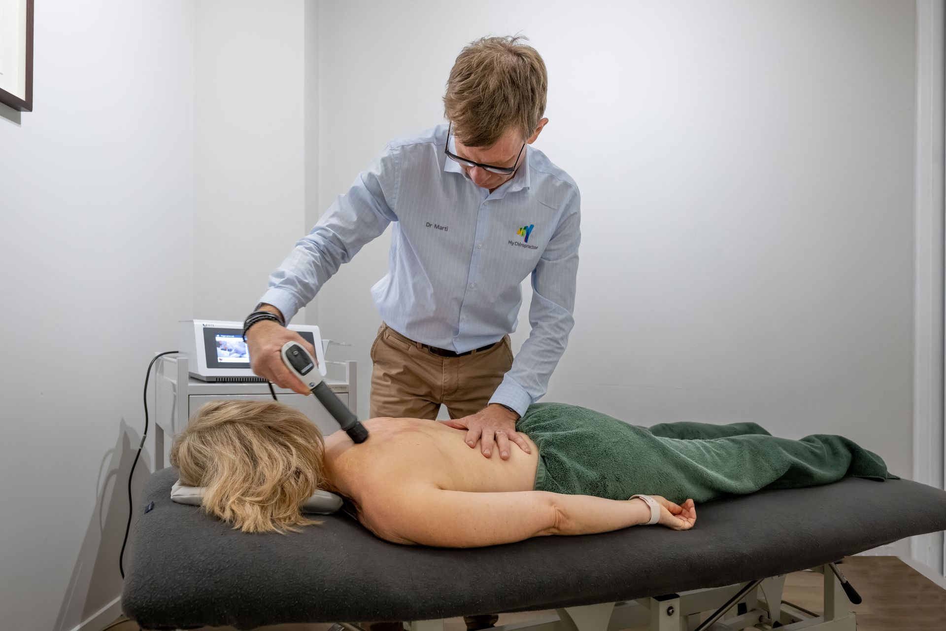 Person Receiving Medical Treatment on Elbow with A Device — My Chiropractor Mackay City in Mackay, QLD